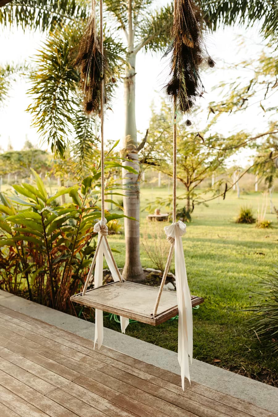 A wooden swing hanging in a green garden, an image of lightness returning in depression therapy
